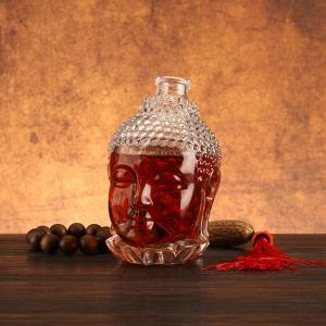 China Unique Buddha Head Shaped Glass Bottles with Aluminum Plastic PP Collar Material factory