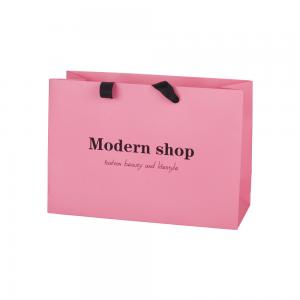 China Pink 250g Coated Paper Bags Packaging Clothing With Ribbon Handle factory